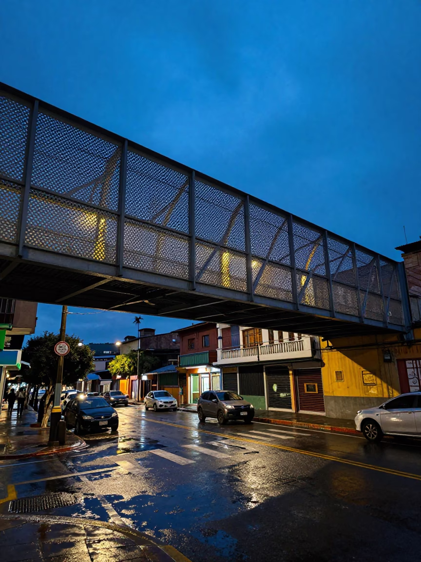 Blue Hour Street Scene in Medellin Colombia with Perforated Metal Overpass and Wet Footsteps in in Medellin, Colombia