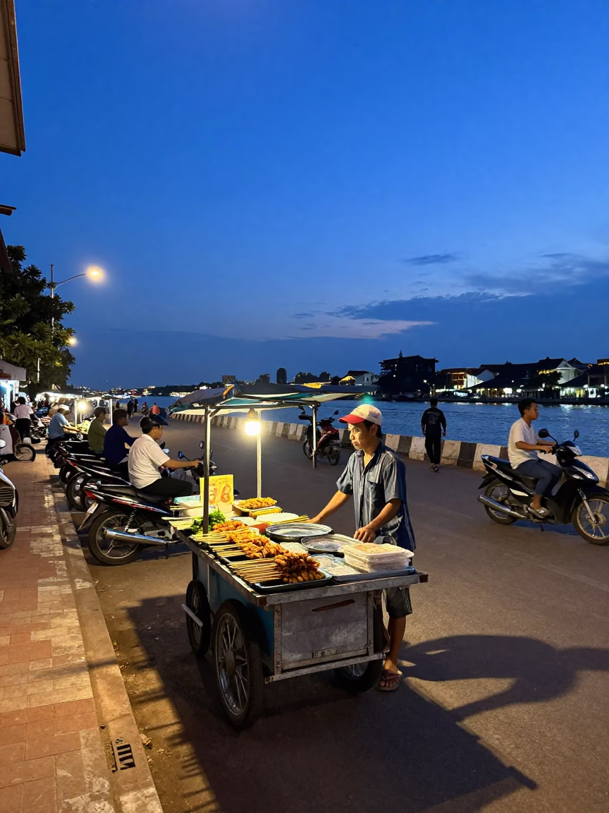 Blue Hour Street Scene in Phnom Penh Cambodia with Food Vendors and Motorbikes in in Phnom Penh, Cambodia