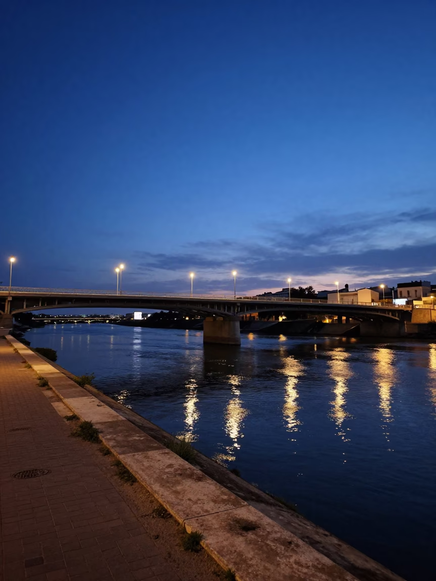 Blue Hour Valencia Spain Street Scene with Bridge Pier and River Reflections in in Valencia, Spain