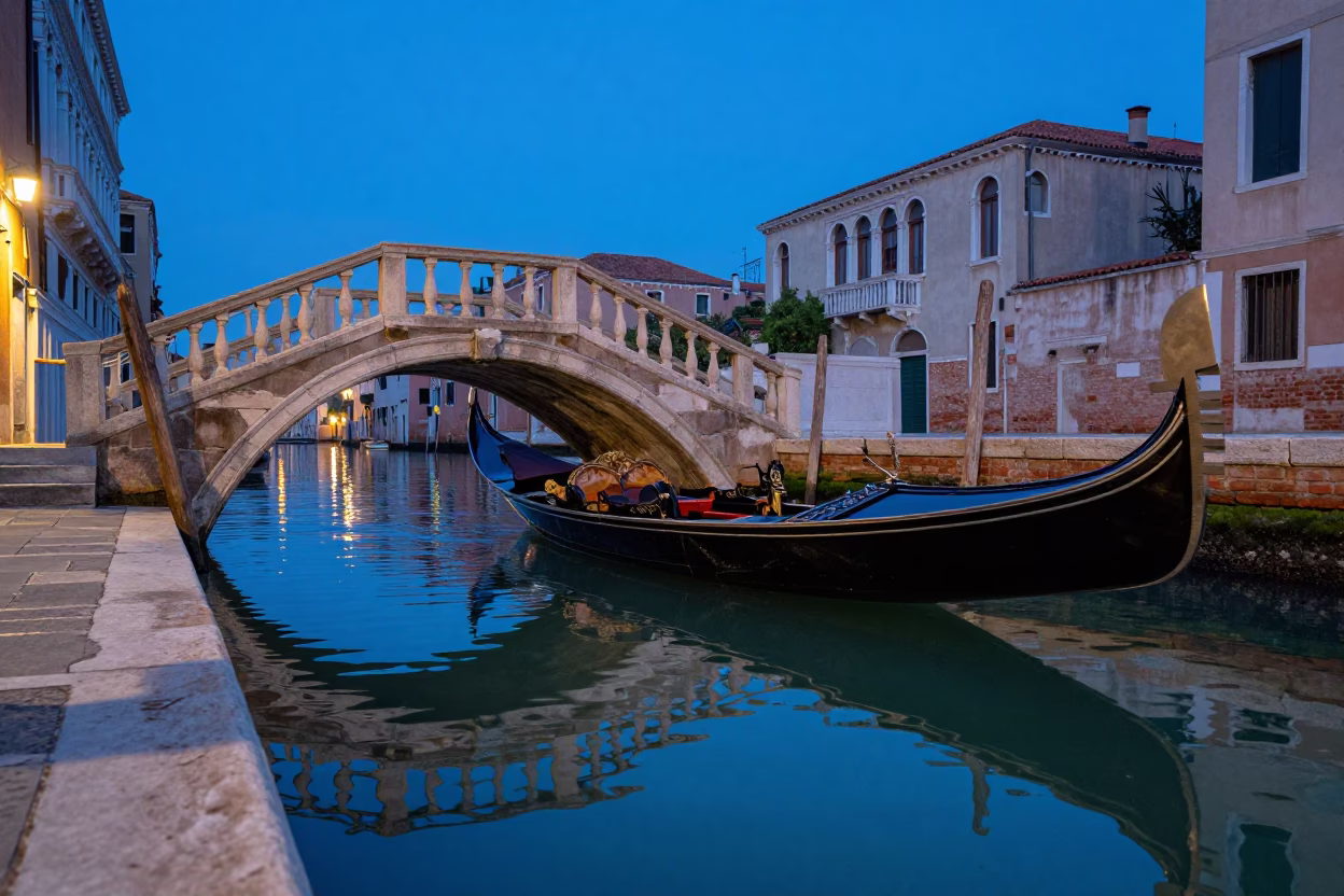 Blue Hour Venice Canal Reflections with Wooden Boat and Stone Bridge in in Venice, Italy