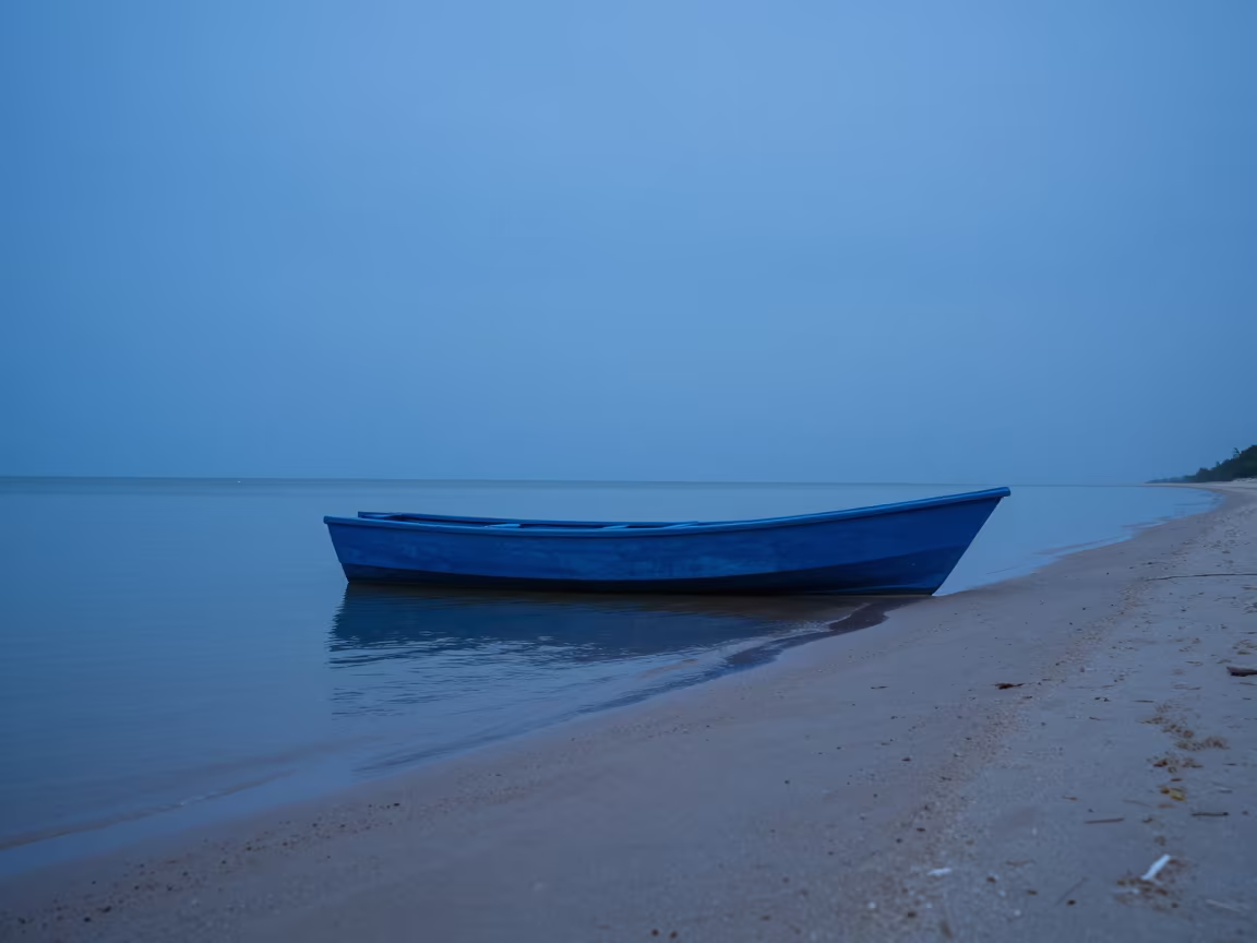 Blue Rowboat on White Sand at Twilight Suriname in across a remote ferry crossing in Suriname