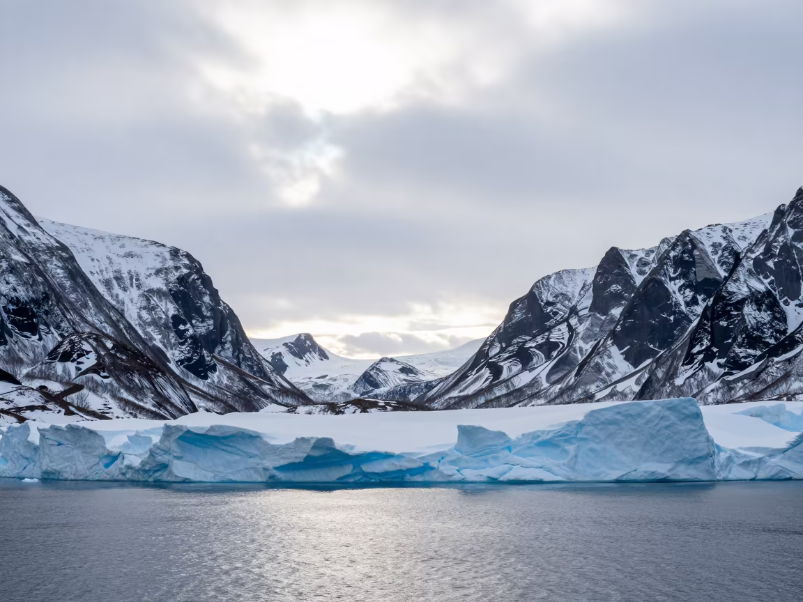 Blue Sea Ice Shelf Edge Under Winter Noon in across a wide valley floor near Tromsø