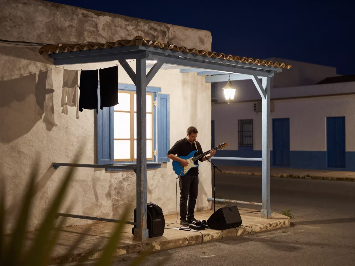 Blues Guitarist Performing on El Jadida Porch Night in at a street corner busking spot in El Jadida