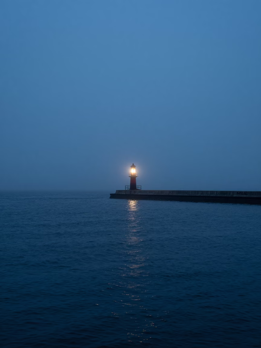 Boston Harbor Pre-Dawn Foggy Horizon with Breakwater Beacon Blinking Through Mist in in Boston, Massachusetts, United States