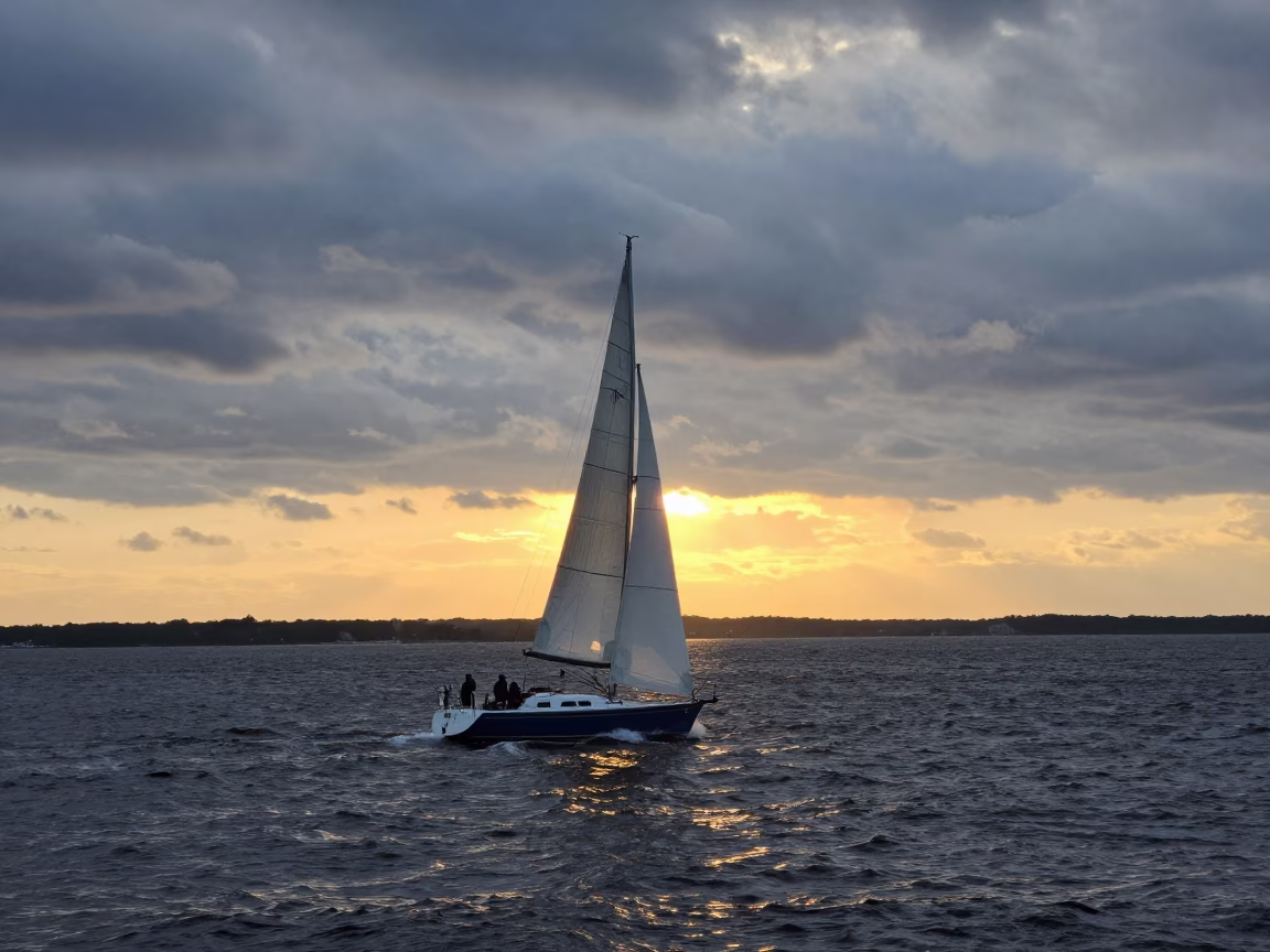 Boston Harbor Sunset Sailboat Tacking Against Darkening Sky in in Boston, Massachusetts, United States