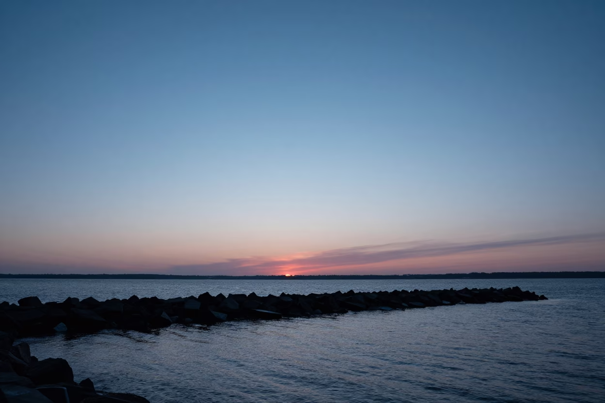 Boston Harbor Sunset View with Blue Hour Sky Fading Above Harbor Breakwater in in Boston, Massachusetts, United States