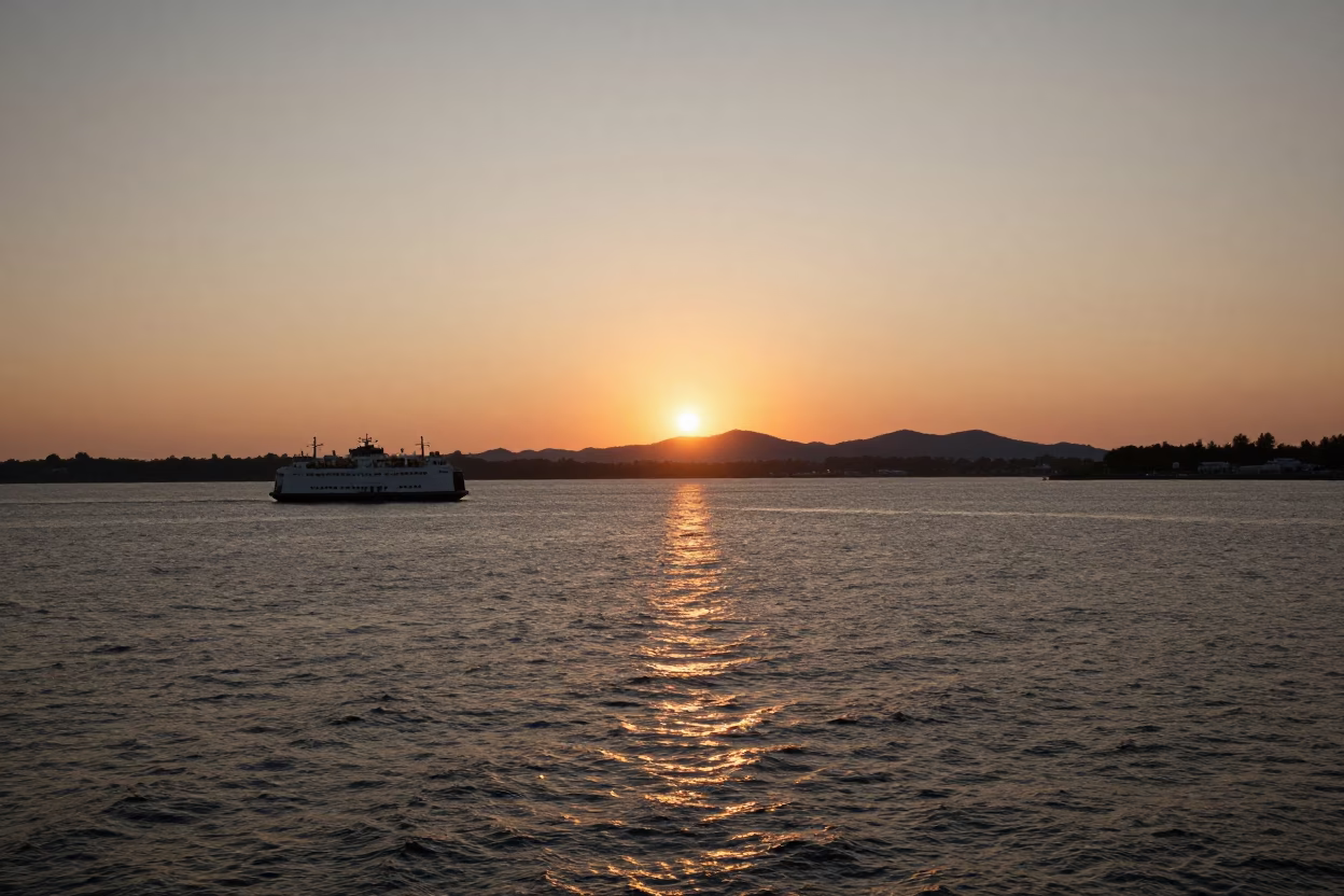 Boston Harbor Sunset with Ferry Departure and Mountain Silhouettes in in Boston, Massachusetts, United States
