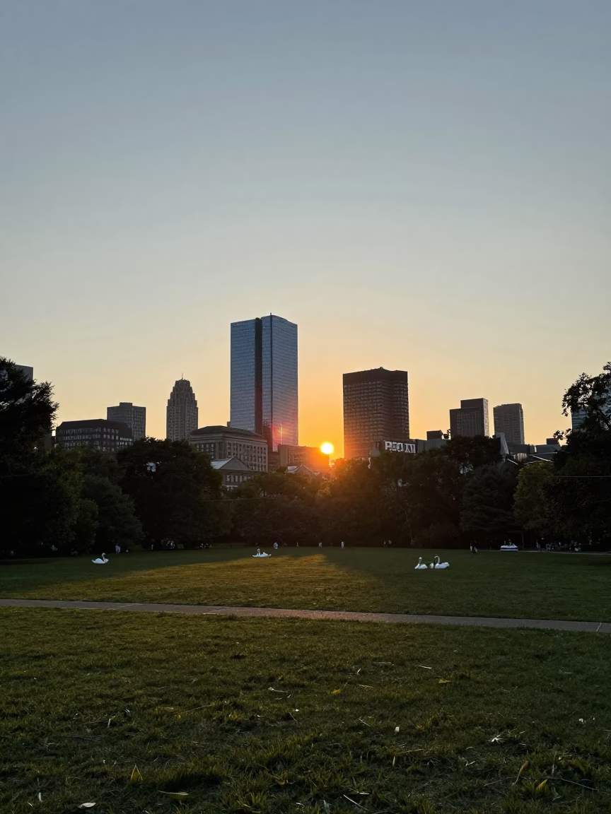 Boston Public Garden sunset with swan boats and city skyline in in Boston, Massachusetts, United States