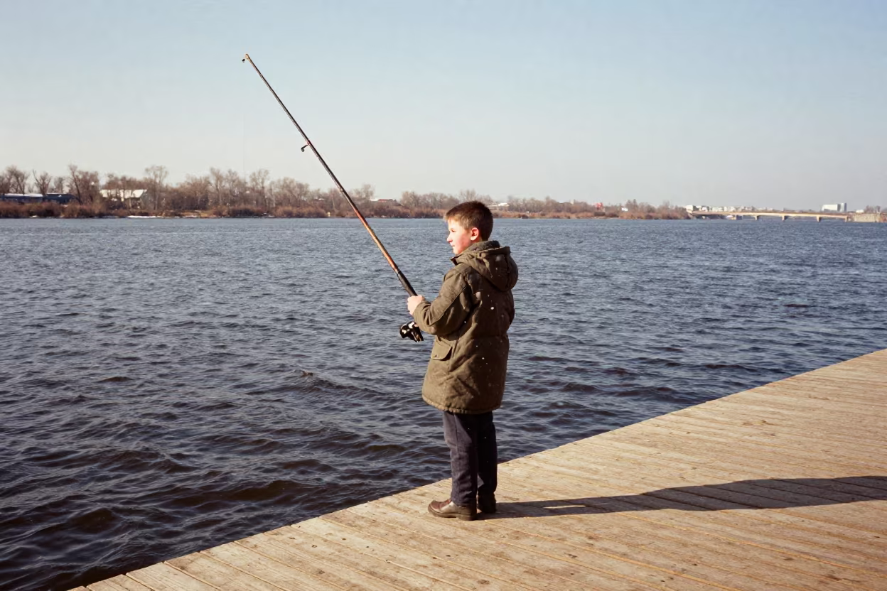 Boy with Oversized Rod on Tolyatti Dock in Snow in near a riverside landing in Tolyatti