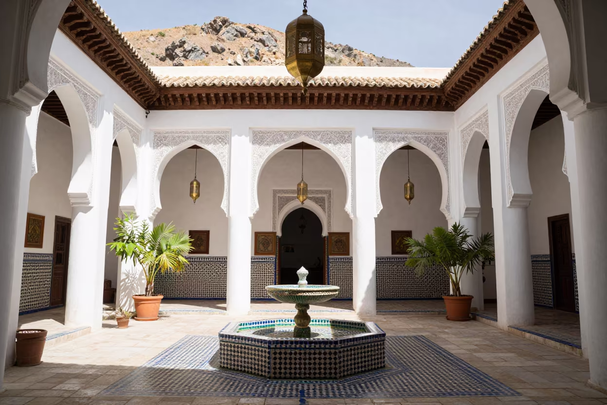 Brass Lanterns Hang Over Zellige Fountain in Riad in in a riad courtyard in Marrakech