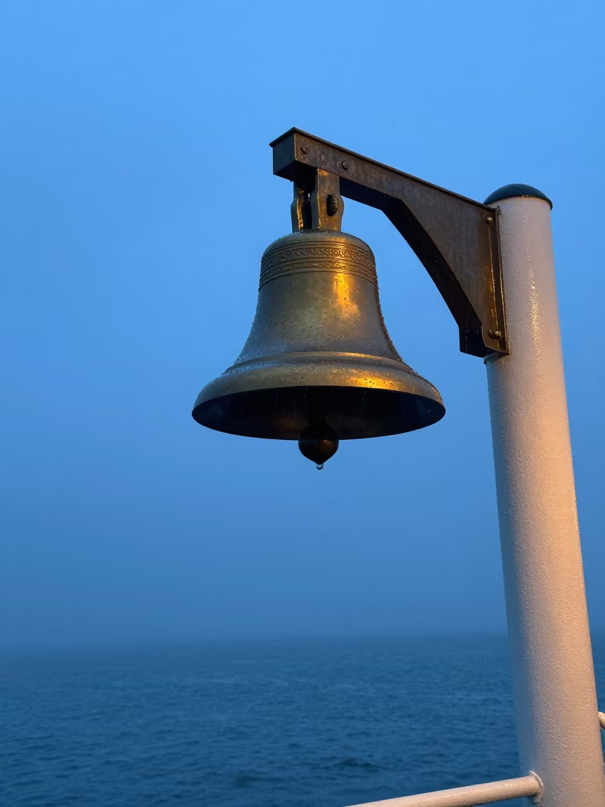 Brass Ship Bell on Ferry at Twilight in across a remote ferry crossing near Oujda