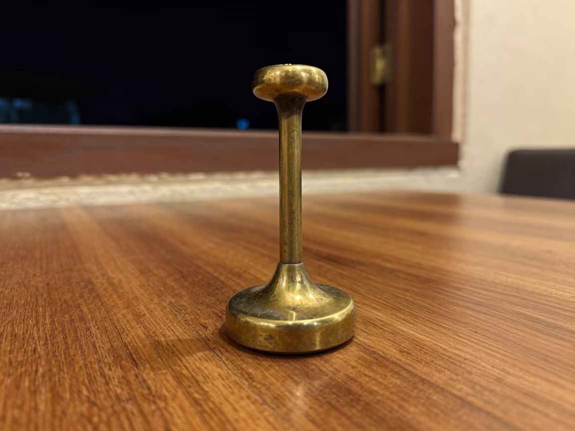 Brass Telegraph Key on Cafe Table Night in on a cafe table by a window in Ouagadougou