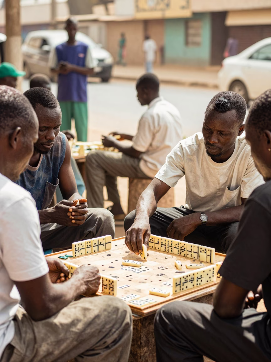 Bright Midmorning Street Scene in Dakar Senegal with Dominoes and Ras Malai in in Dakar, Senegal