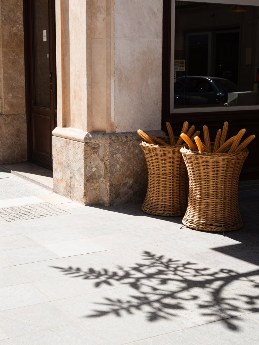 Bright Midmorning Street Scene in Valencia Spain with Churros and Wicker Shadows in in Valencia, Spain