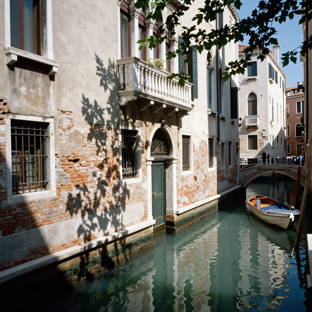 Bright Midmorning Sunlight on Venice Canal with Leaf Shadows and Narrow Waterway in in Venice, Italy