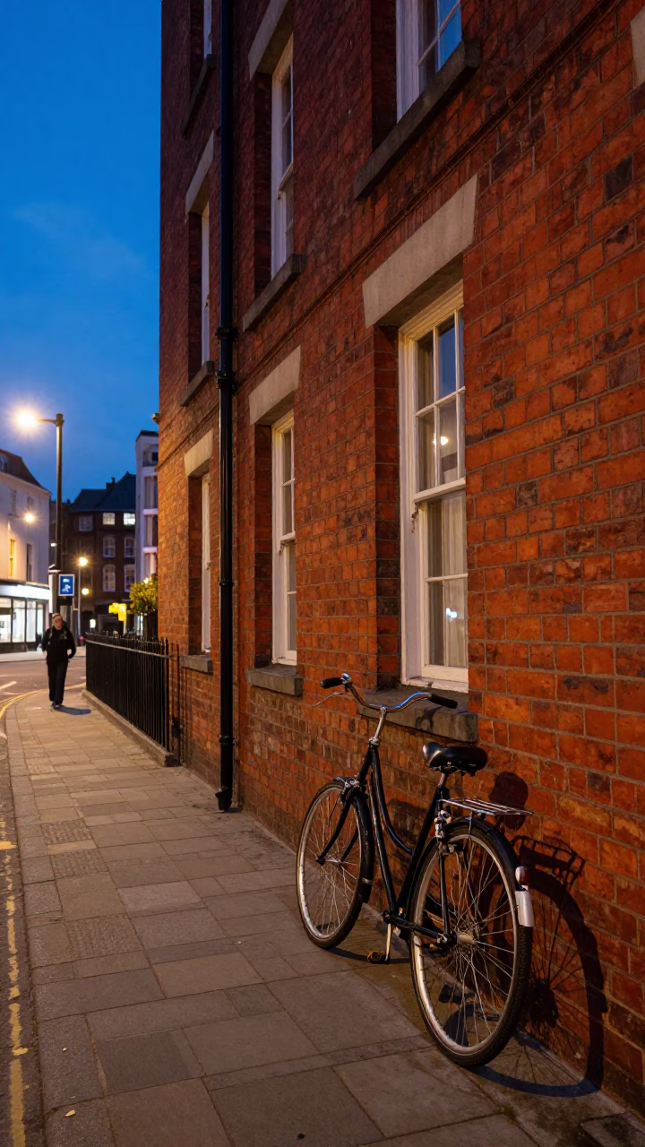 Bristol City Lights Glow Over Red Brick Architecture and Street Scene at Dusk in in Bristol, United Kingdom