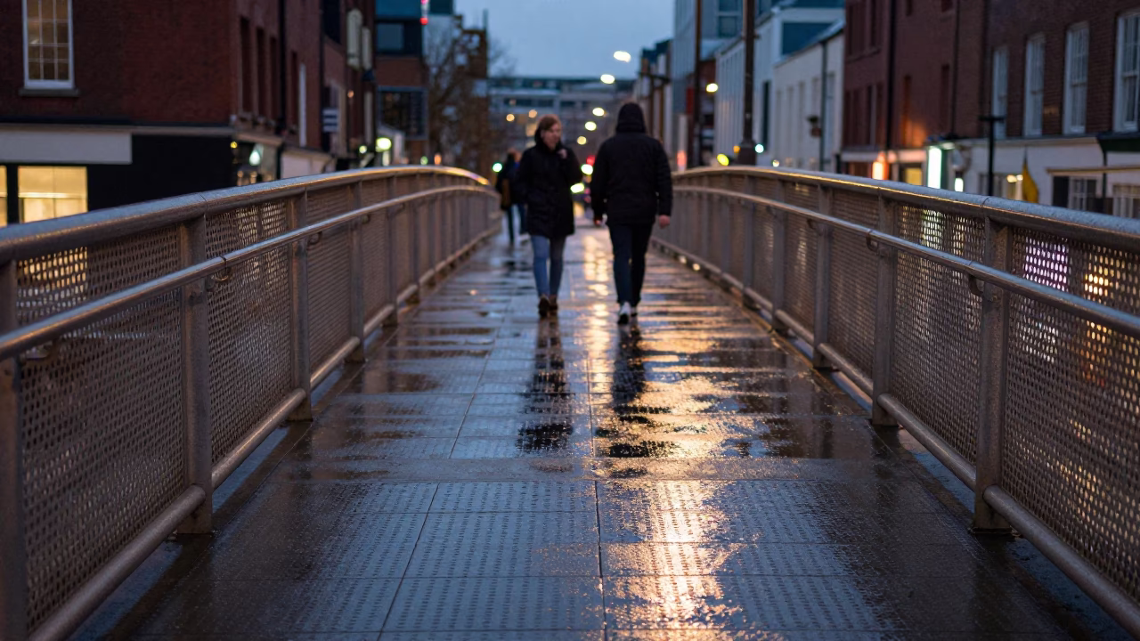 Bristol UK Evening Pedestrian Overpass Wet Footsteps Perforated Metal City Lights Glow in in Bristol, United Kingdom