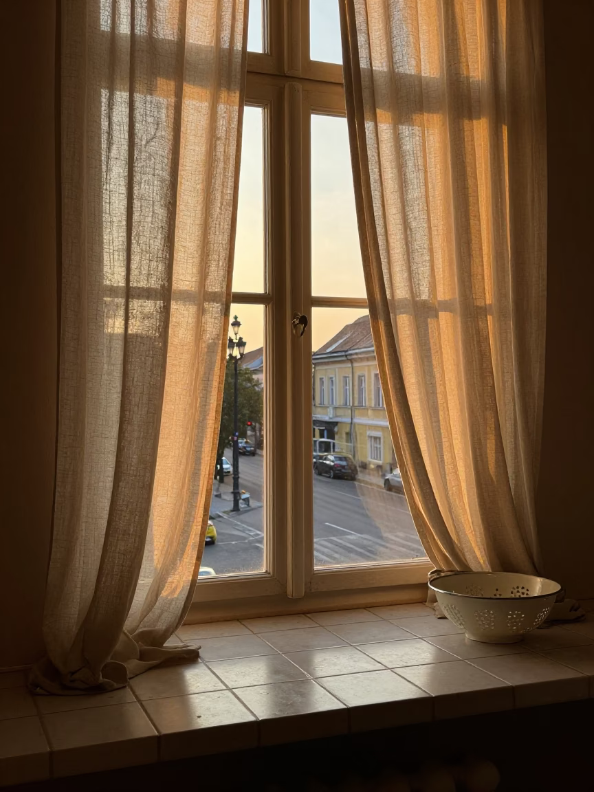 Budapest Evening Street Scene with Linen Curtains and Window Light on Countertop in in Budapest, Hungary