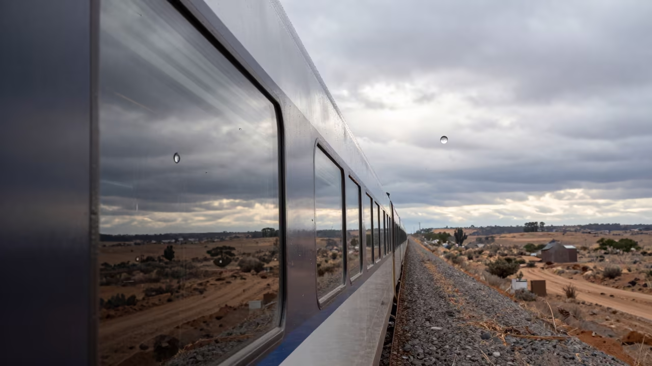 Bullet Train Reflected in Window Frozen Mid-Fall in on a wind-open causeway near Bloemfontein