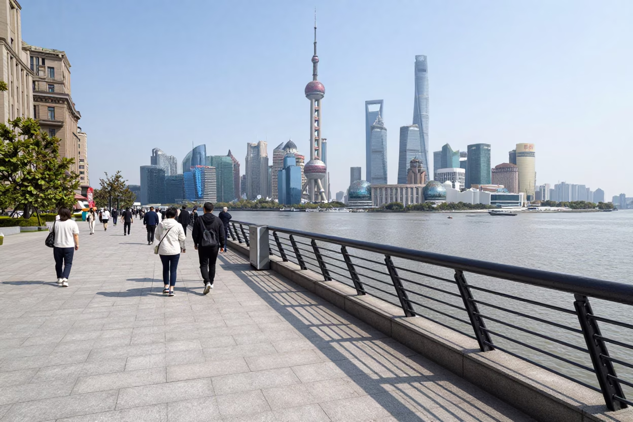 Bund promenade pedestrians and Huangpu River skyline at midday Shanghai China in in Shanghai, China
