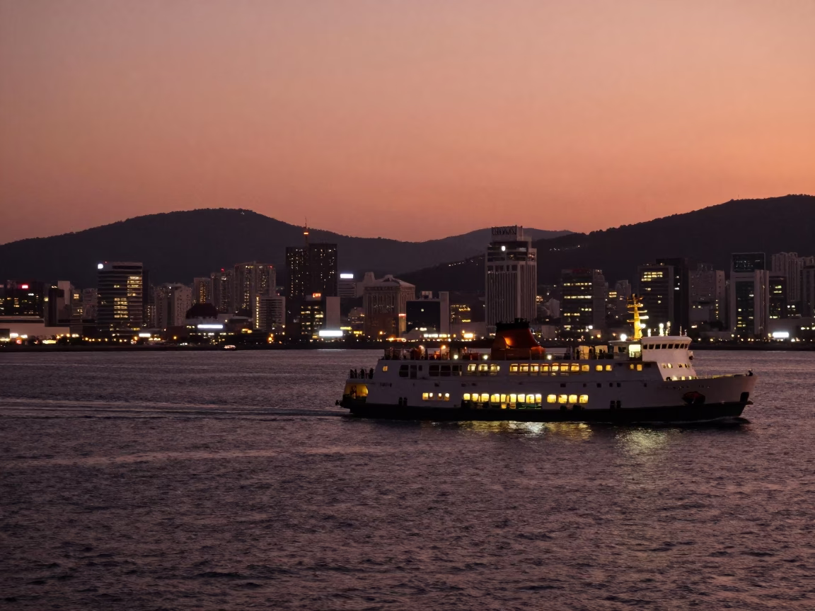 Busan South Korea harbor dusk scene with ferry lights and copper sky in in Busan, South Korea
