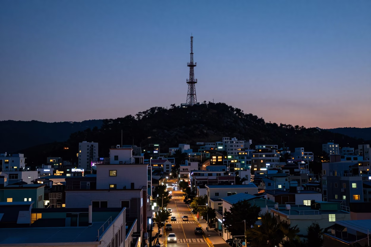 Busan South Korea indigo twilight street scene with rooftop telecommunication mast and urban skyline in in Busan, South Korea