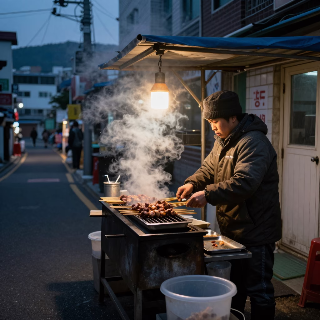 Busan South Korea street food vendor predawn steam and lantern light in in Busan, South Korea