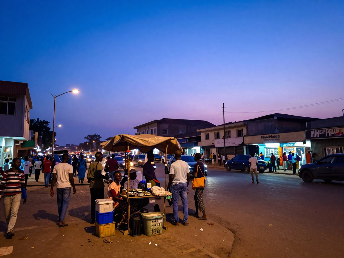 Busy Accra Street Corner at Dusk with Vendor and Local Activity in in Accra, Ghana