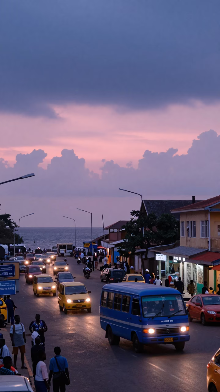 Busy Accra Street Scene at Nautical Dawn with Minibus and Market Activity in in Accra, Ghana
