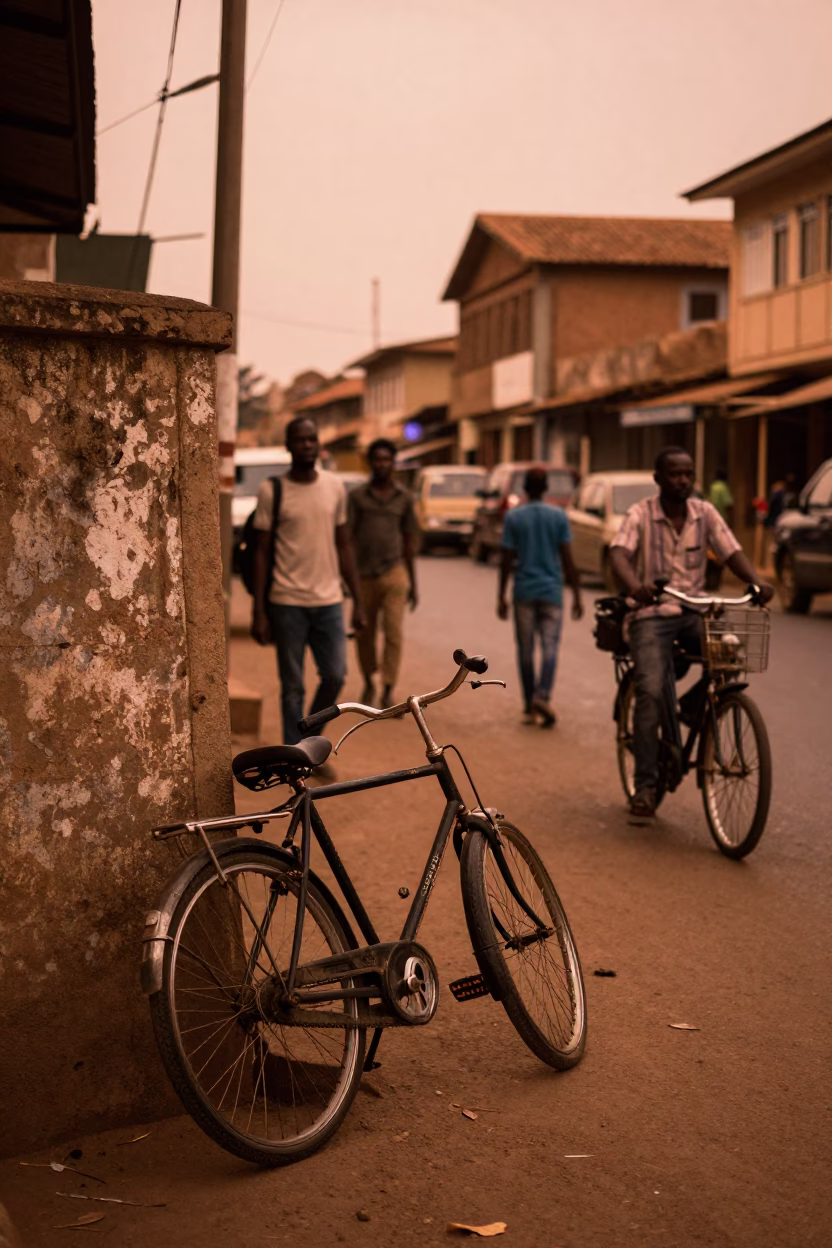 Busy Accra Street Scene in Copper Light with Vintage Bicycle and Local Market Activity in in Accra, Ghana