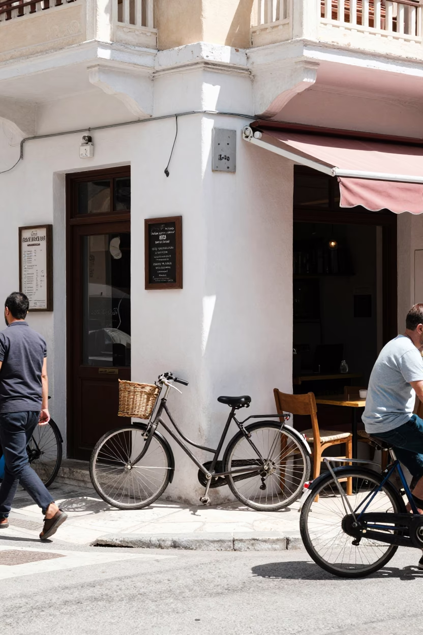 Busy Athens Street Scene with Bicycle Leaning Against Cafe in Bright Midmorning Light in in Athens, Greece