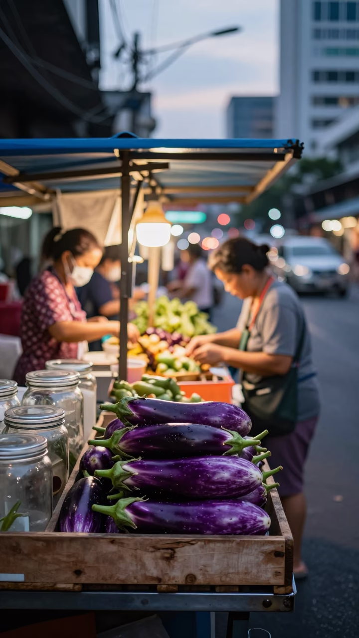 Busy Bangkok Street Stall Early Evening with Eggplants and Glass Jar in in Bangkok, Thailand