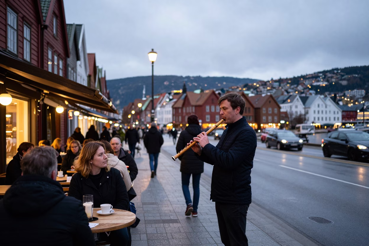Busy Bergen Norway Street Scene at Dusk with Wooden Flute Player and Bar Stools in in Bergen, Norway