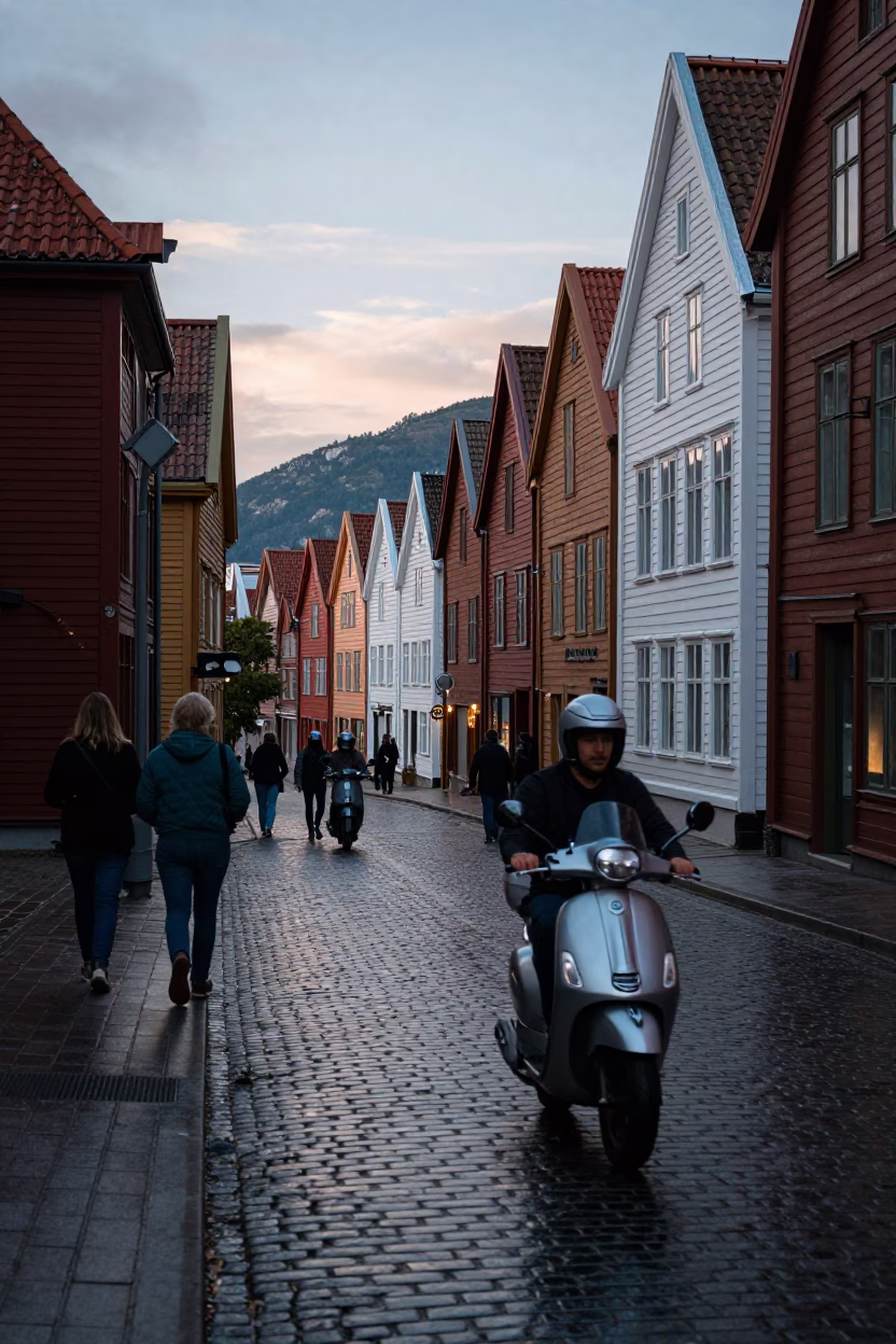 Busy Bergen Norway Street Scene Early Evening with Scooter and Colorful Houses in in Bergen, Norway