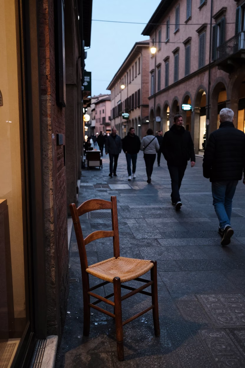 Busy Bologna Street Scene Early Evening with Ladder-Back Chair and Pedestrians in in Bologna, Italy