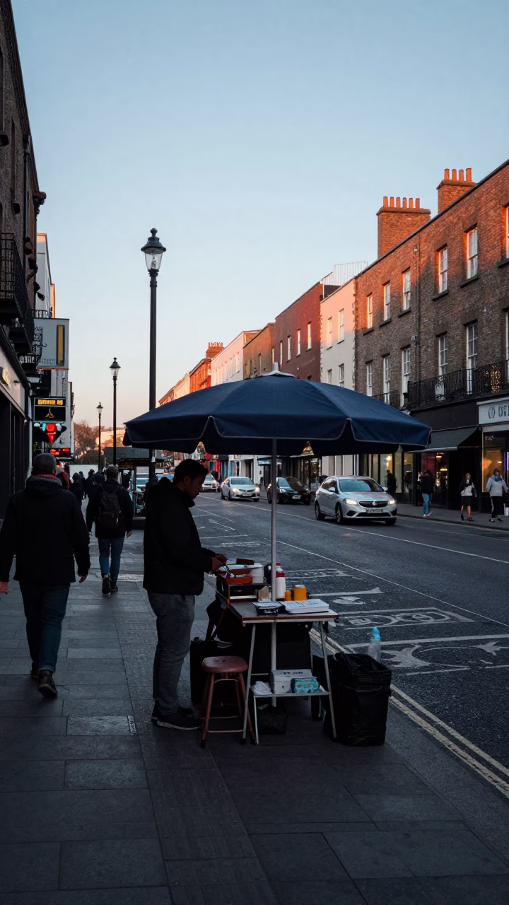 Busy Dublin Street Scene Before Sunrise with Umbrella Stand and Colander in in Dublin, Ireland
