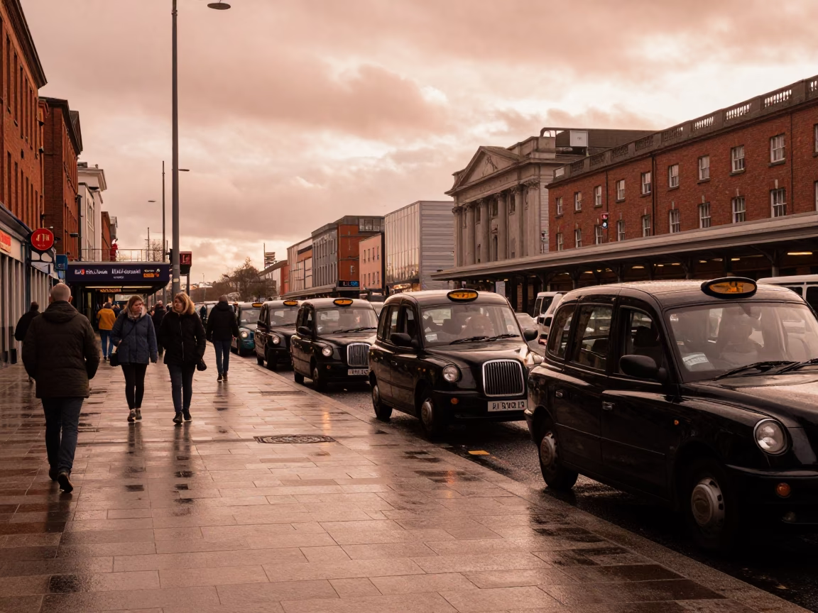 Busy Dublin Taxi Rank Outside Train Station in Copper Toned Twilight Light in in Dublin, Ireland