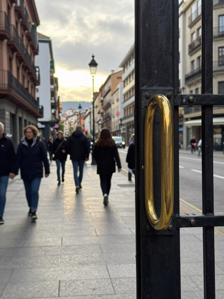 Busy Early Afternoon Street Scene in Bilbao Spain with Polished Brass Gate Handle in in Bilbao, Spain