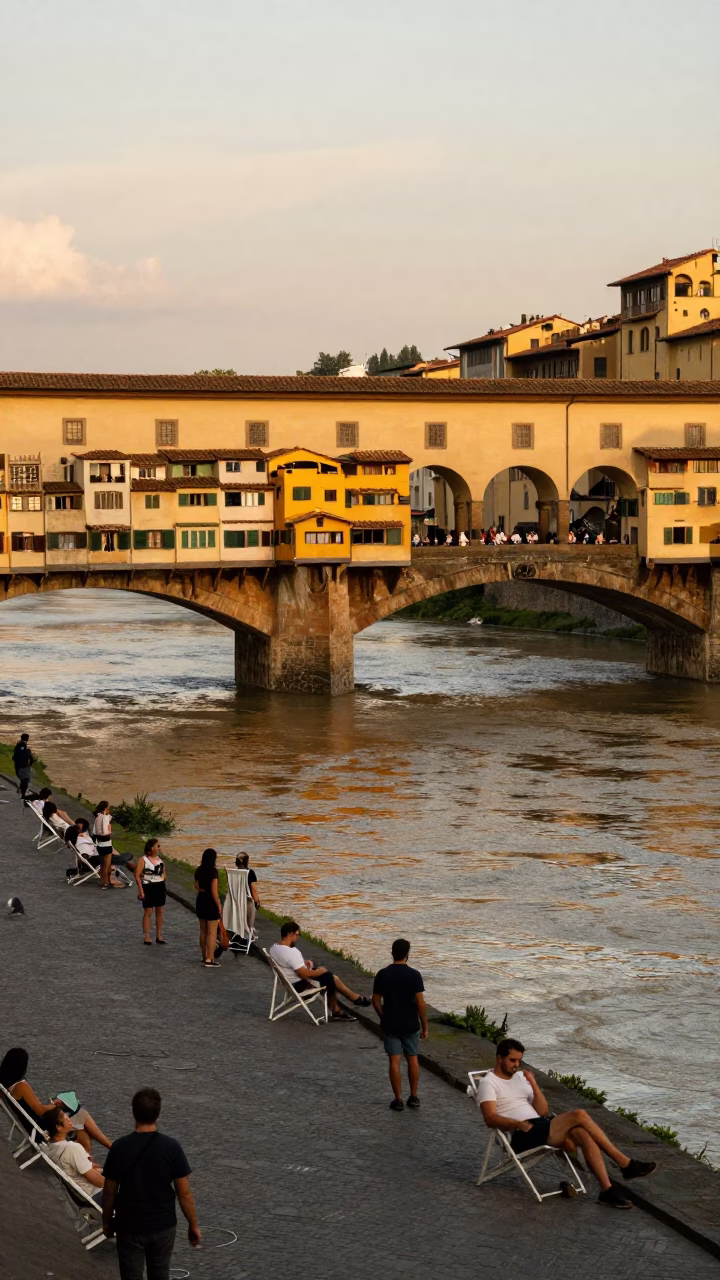 Busy Florence Sunset Street Scene with Bridge Pier and Deck Chairs in in Florence, Italy