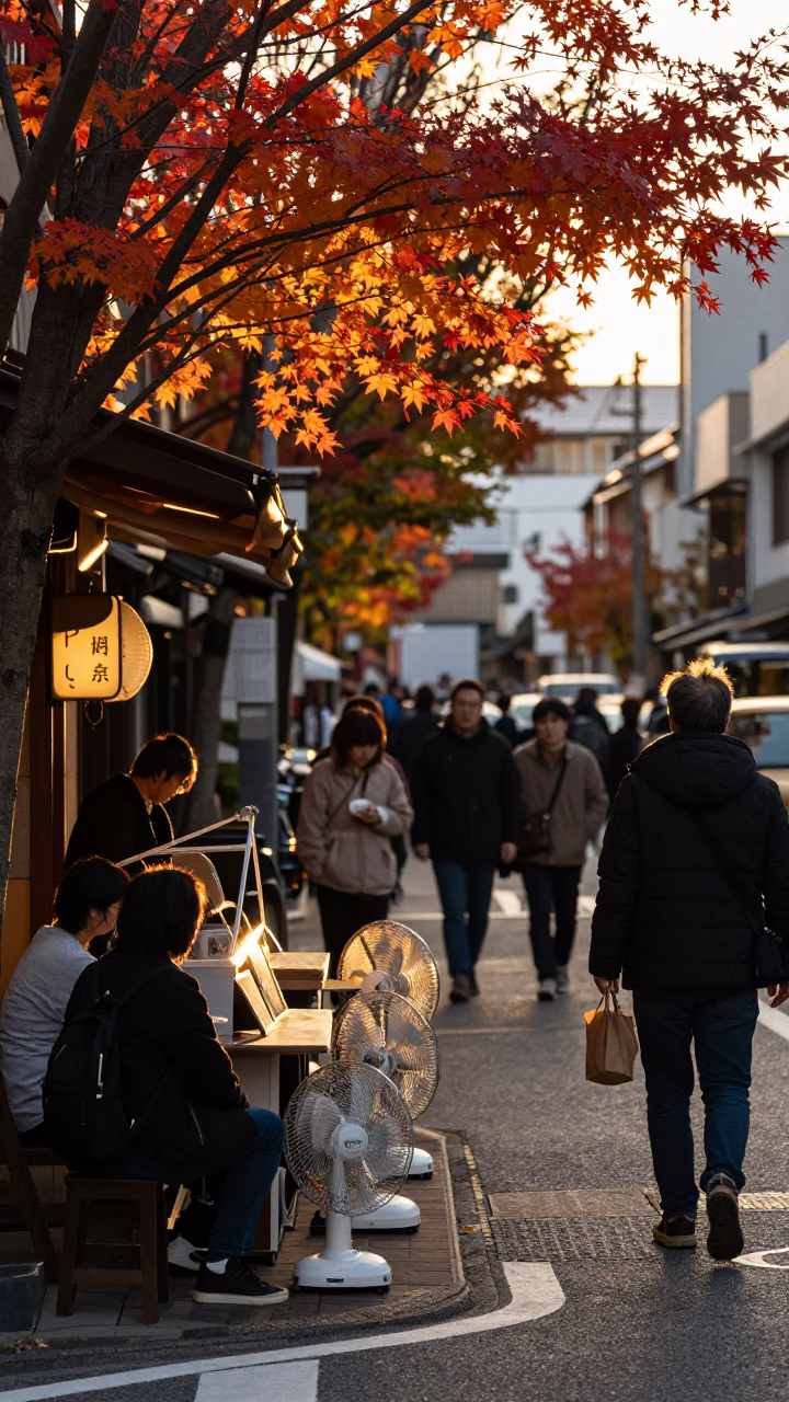 Busy Fukuoka Street Scene at Golden Hour with Autumn Maple Leaves and Table Fans in in Fukuoka, Japan