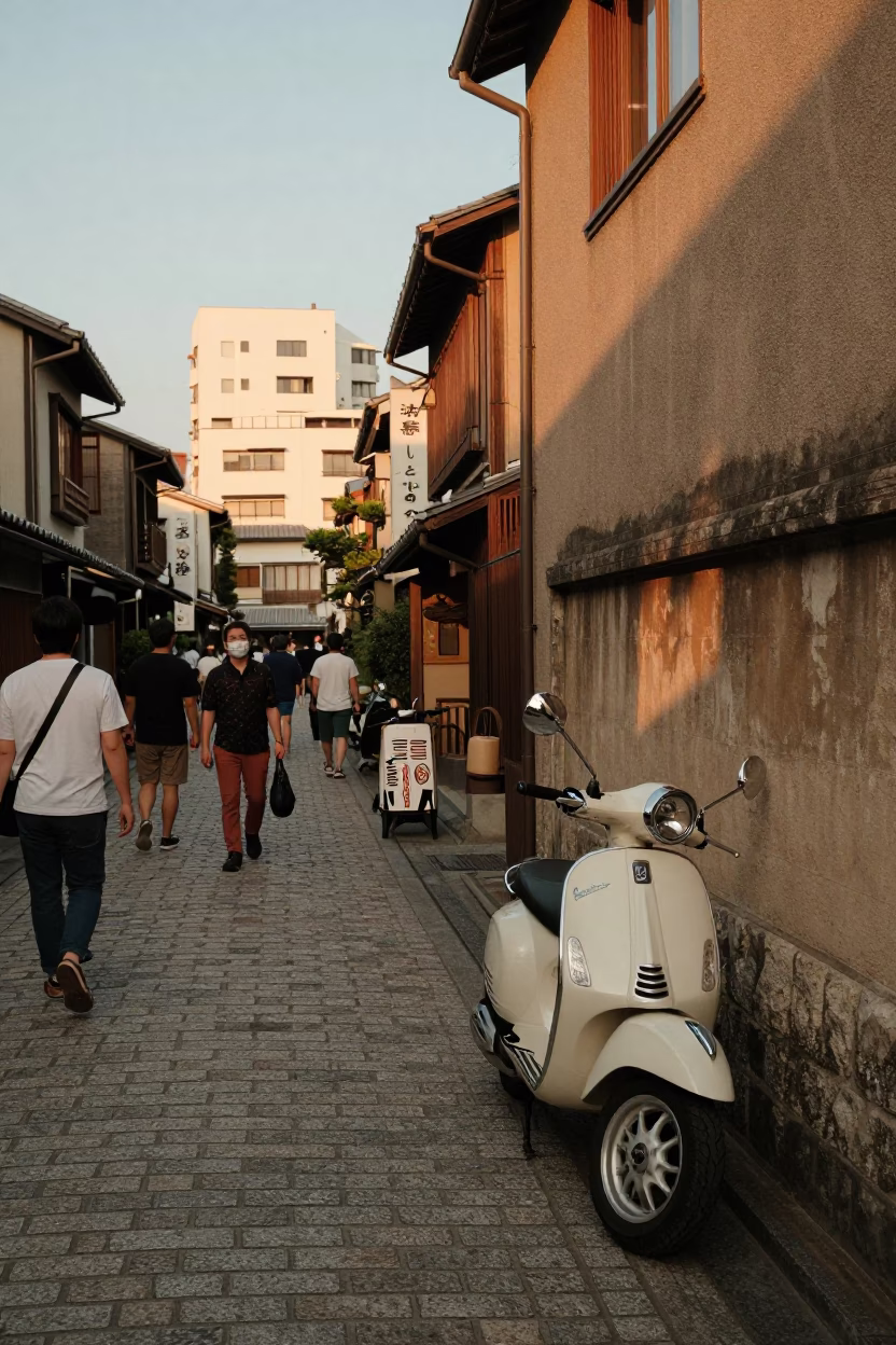 Busy Fukuoka Street Scene in Honeyed Evening Light with Vintage Vespa and Folding Chair in in Fukuoka, Japan