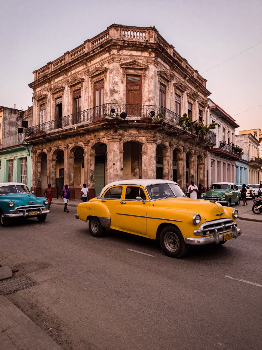 Busy Havana Street Corner with Vintage Cars and Local Life Before Dusk in in Havana, Cuba