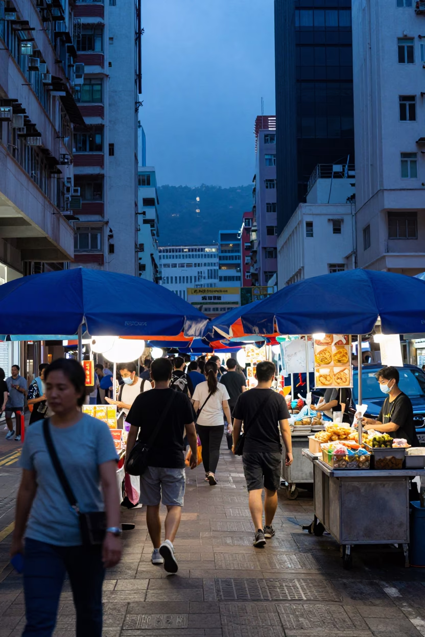 Busy Hong Kong Street Scene with Umbrellas in Evening Blue Light in in Hong Kong, Hong Kong