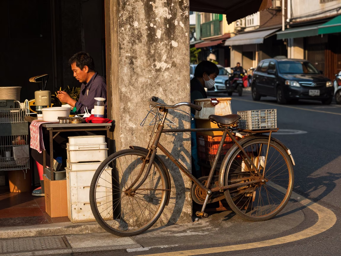 Busy Kaohsiung Street Corner Late Afternoon with Vintage Bicycle and Fruit Crates in in Kaohsiung, Taiwan