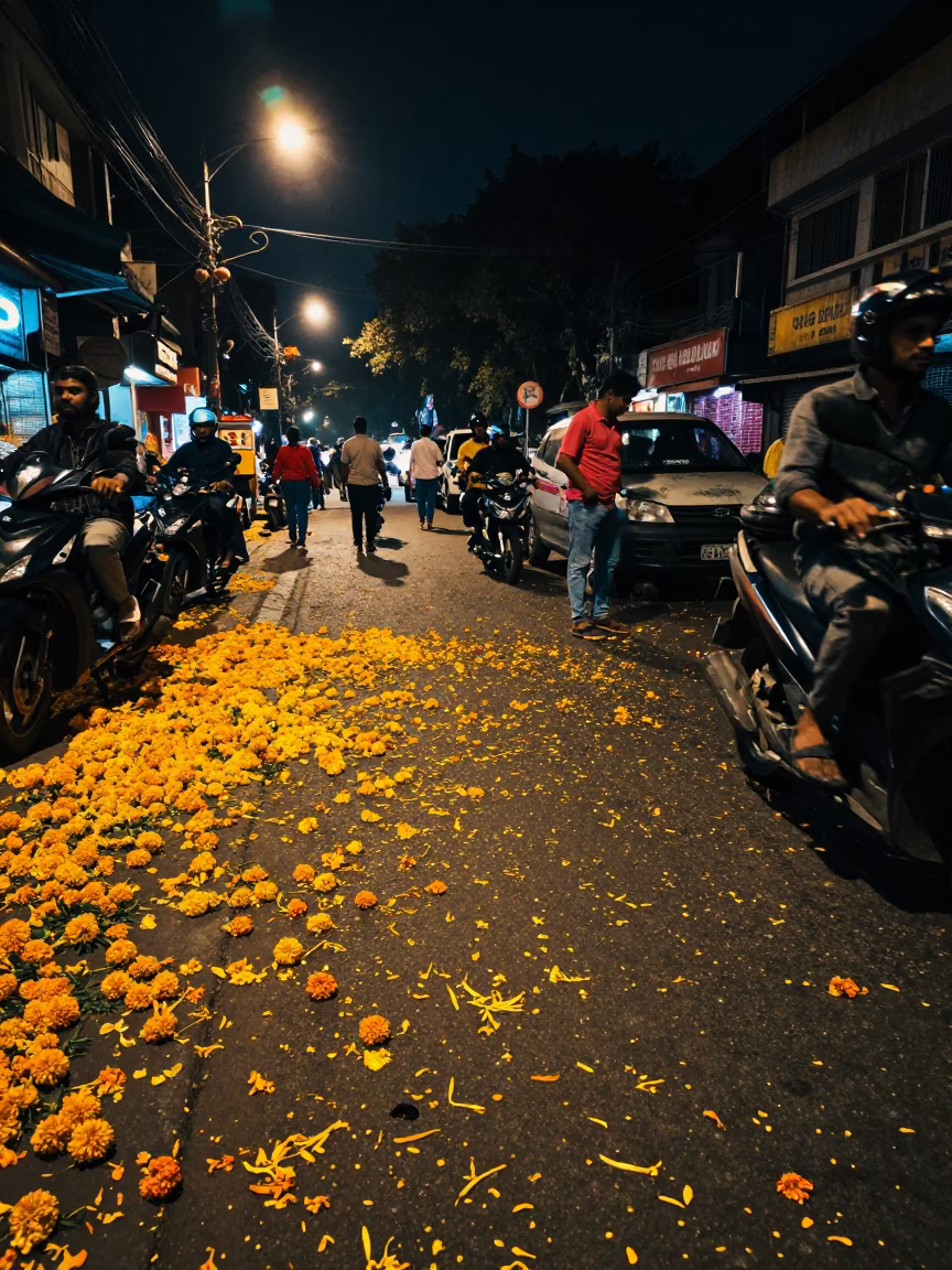 Busy Kolkata Night Street Scene with Fallen Petals and Colorful Lights in in Kolkata, India