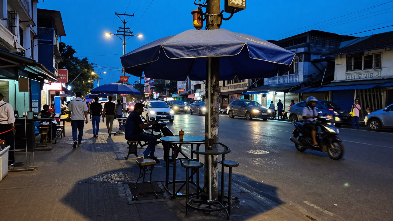 Busy Kolkata Street Scene at Blue Hour with Umbrella Stand and Smudged Table in in Kolkata, India