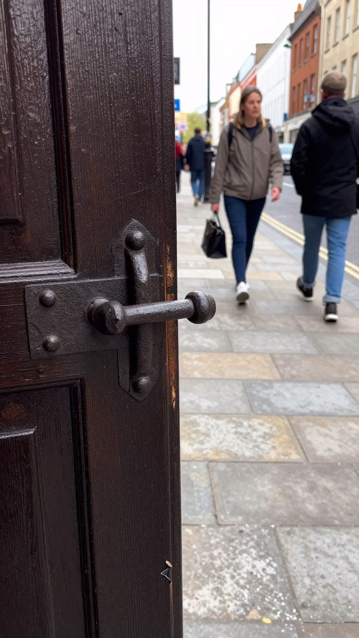 Busy Liverpool Street Scene with Iron Deadbolt and Cracked Stucco in Late Morning Light in in Liverpool, United Kingdom