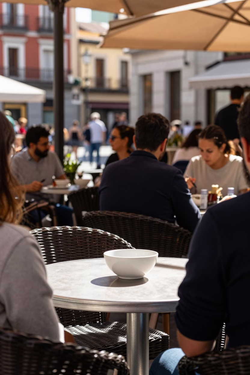 Busy Madrid Cafe Terrace Noon Light with Wicker Shadow and Ceramic Bowl in in Madrid, Spain