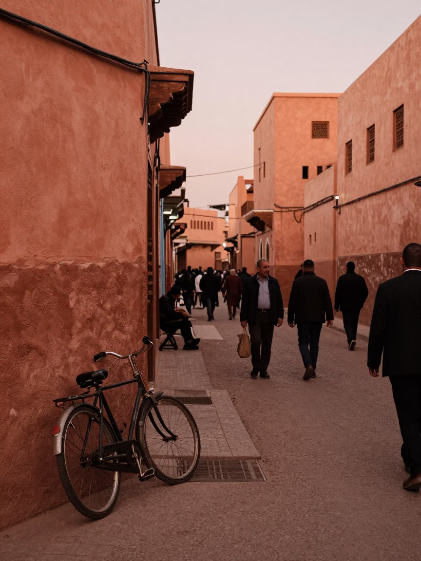 Busy Marrakech Street Scene in Copper Toned Dusk Light with Vintage Bicycle and Geraniums in in Marrakech, Morocco