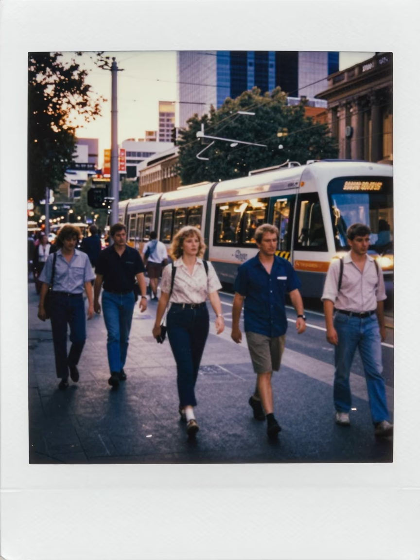 Busy Melbourne Street Scene Early Evening with Monorail Reflection in Glass Skyscraper in in Melbourne, Victoria, Australia